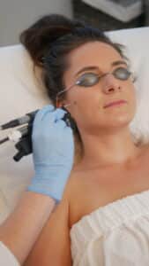 Woman receiving laser facial treatment at Olakino Laser + Skin in Victoria